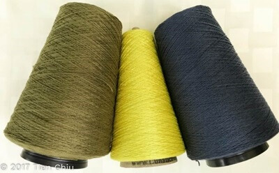 three cones of yarn, in Olive, yellow-green and navy